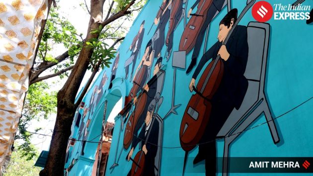 The mural also features sheet music notes wafting above a musically absorbed orchestra drawn in classic black-and-white outfits