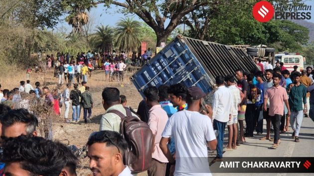 In the impact, the front section of the container broke apart and fell onto the truck, trapping several passengers underneath