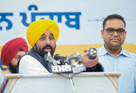 Punjab Chief Minister Bhagwant Mann addresses during the inauguration of the underground electricity project, at village Satauj, in Sangrur on Tuesday. (@AAPPunjab X/ANI Photo)
