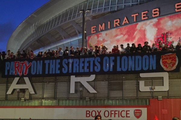Arsenal supporters gather at the Arsenal stadium after Arsenal won the Premier League title in London. (AP Photo/Alberto Pezzali)