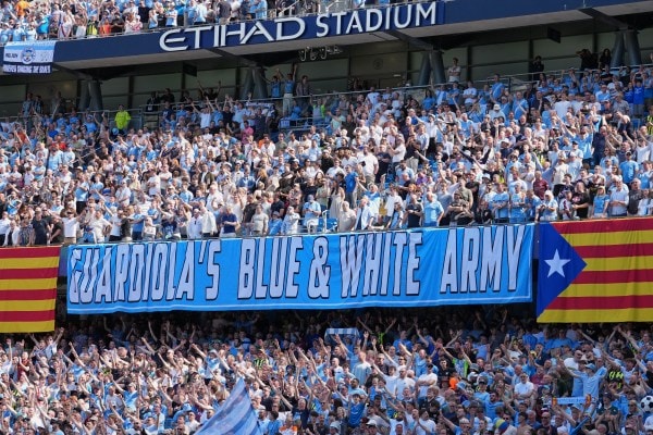 Manchester City fans holds a sign thanking the coach Pep Guardiola during his last match as a manager during a Premier League match against Aston Villa on Sunday. (AP Photo)