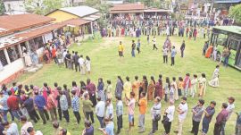 People wait in a queue to cast their vote at Latakata polling station during the Assam Legislative Assembly elections on April 9. (ANI Photo)