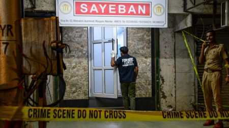 Police and forensic officials inspect the site of an alleged firing incident in which a man sustained bullet injuries, at Dockyard Road, Byculla. (PTI Photo) crime branch