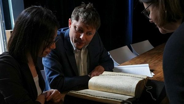 (From left) Elisabetta Magnanti and Mark Faulkner from Dublin's Trinity College and Valentina Longo of Rome's National Central Library look at a manuscript containing a rare, long-lost copy of Caedmon's Hymn, the first poem ever to be written down in Old English, at Rome's National Library. (AP Photo/Andrea Rosa)
