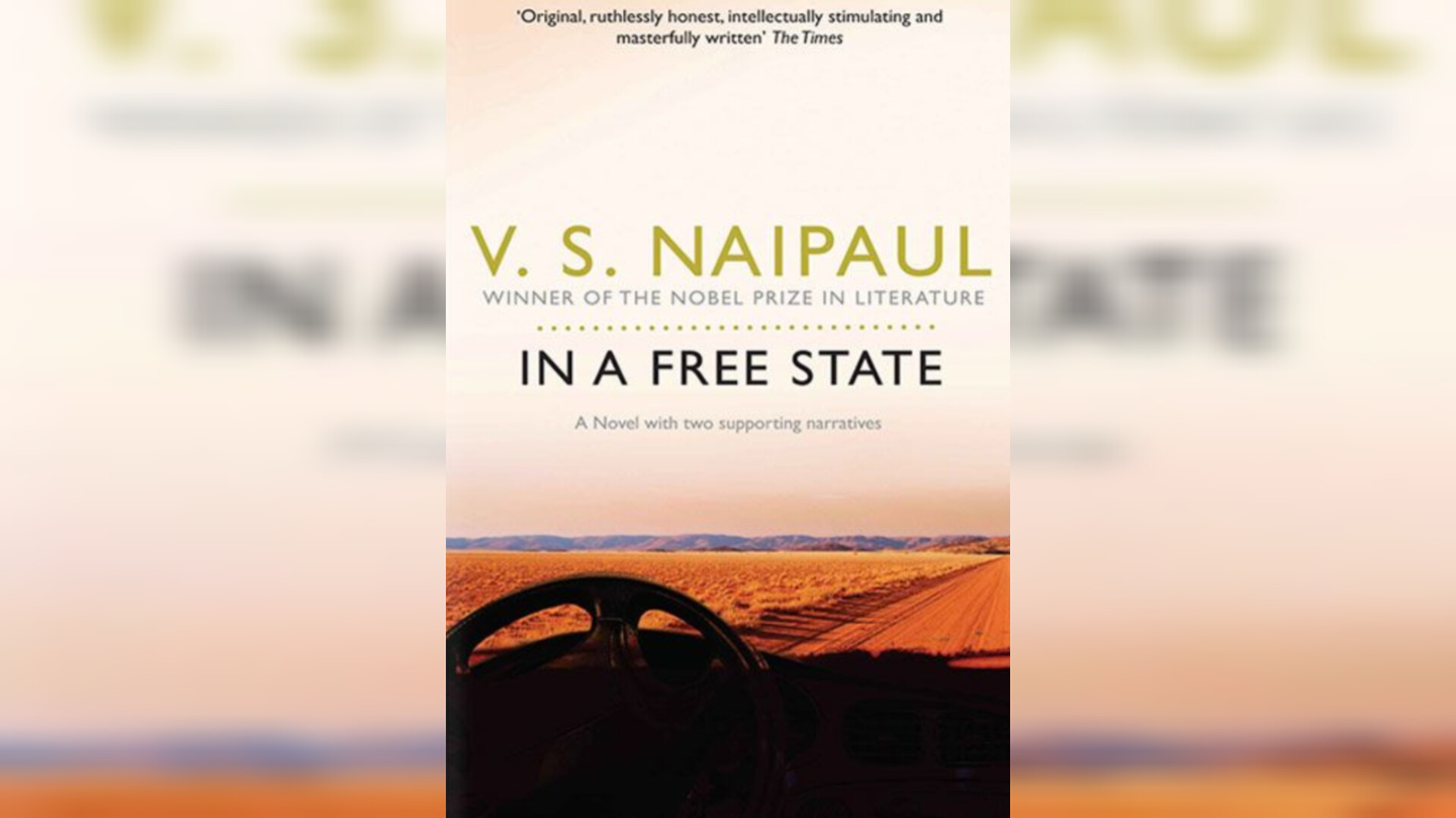 V.N. Naipaul's book In a free state won the international booker prize. This is a cover page showing, an empty deserted road and a car wheel. 