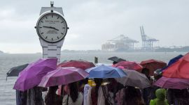 Visitors at the Marine Drive on a rainy afternoon, in Kochi. (PTI Photo)