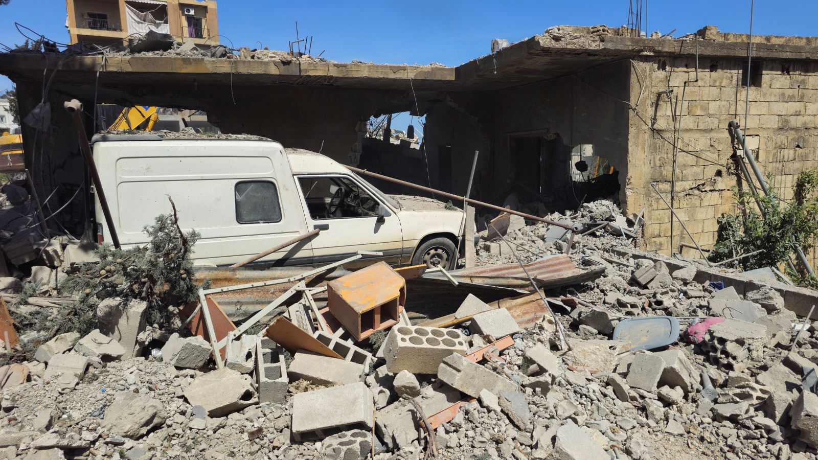 A vehicle remains trapped amid the rubble of a destroyed building in the Lebanese town of Habboush, following Israeli strikes, Nabatieh Governorate, on May 2, 2026. (REUTERS)