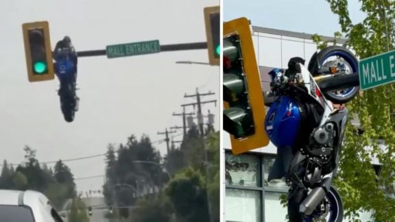 The viral video shows the motorcycle suspended awkwardly from the pole