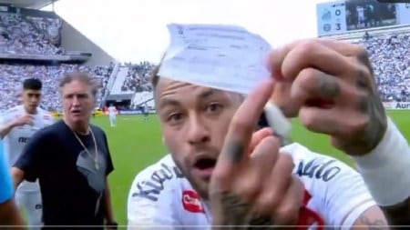 Neymar snatched the official substitution request sheet from the fourth official and held it up in front of the TV cameras to tell broadcasters that Santos coach Cuca had written teammate Escobar's number on it rather than Neymar's. (Screengrab via X)