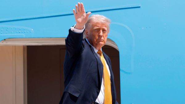 President Donald Trump waves from the stairs of Air Force One as he boards upon his arrival at Joint Base Andrews, Md., Tuesday, May 12, 2026, for a trip to China to meet President Xi Jinping. (AP Photo)
