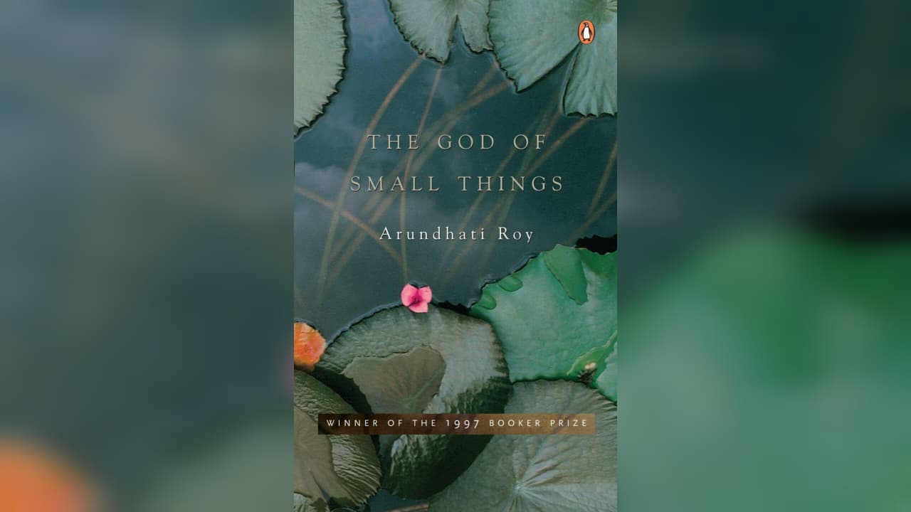 This is a cover of the book the god of small thing, with lotus petal at the background in green colour. 
