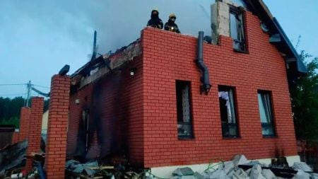 Damaged building exterior and debris seen after a Ukrainian drone attack outside Moscow, as shown in an official image shared by regional authorities.