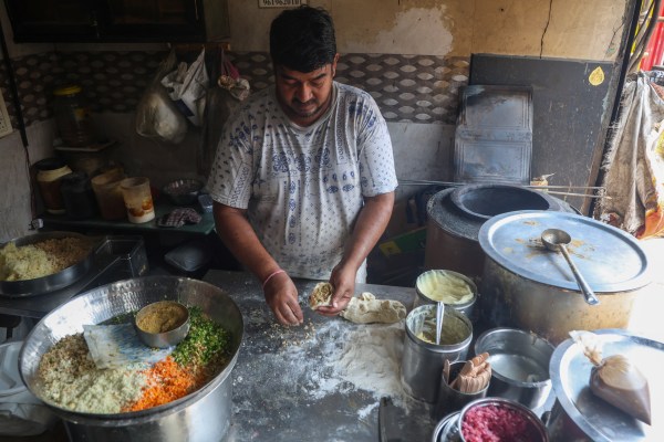 Vijay Mehra, whose father started Sainath Dhaba, making aloo kulcha. (Express Photo by Akash Patil)