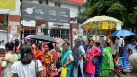 Residents queue up at the Siliguri Head Post Office to link their Aadhaar cards with bank accounts for enrolment in the Annapurna Bhandar scheme (PTI Photo)