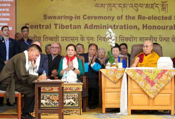 Dharamshala: Re-elected Sikyong of the Central Tibetan Administration, Penpa Tsering signs documents after taking oath in the presence of spiritual leader 14th Dalai Lama during the swearing-in ceremony, in Dharamshala, Himachal Pradesh, Wednesday, May 27, 2026. (PTI Photo)(PTI05_27_2026_000123A)