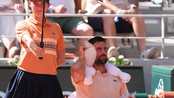 Novak Djokovic of Serbia cools himself with the ice during a break of the second round men's singles tennis match against Valentin Royer at the French Open. (AP Photo)