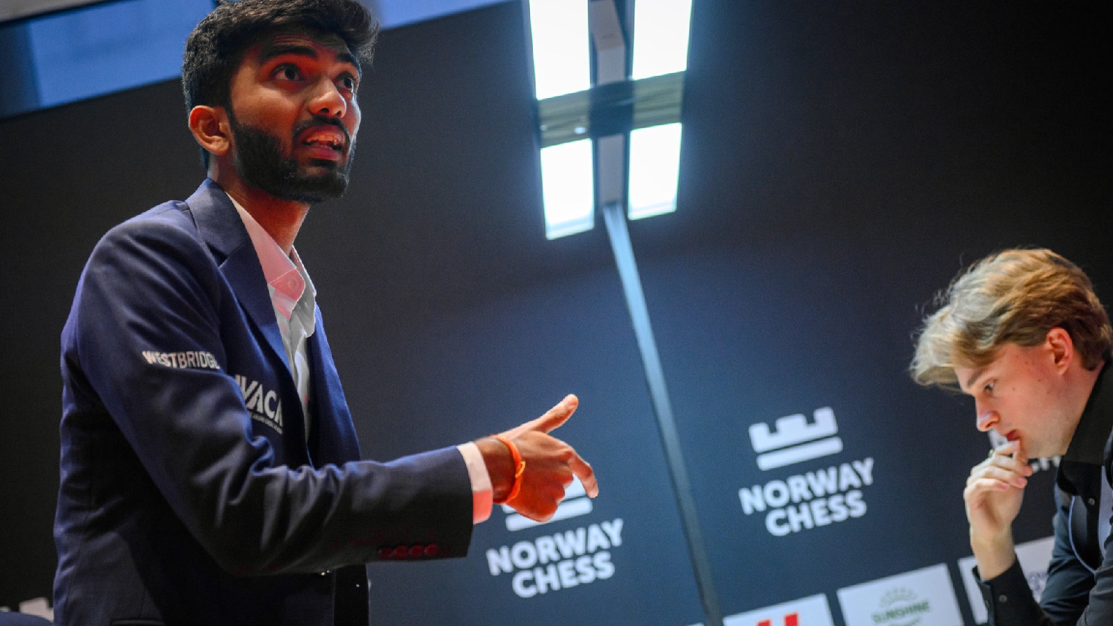 World champion D Gukesh speaks to the arbiter while his opponent Vincent Keymer contemplates his next move during their round 1 game at the Norway Chess tournament in Oslo. (Photo: Michal Walusza/Norway Chess)
