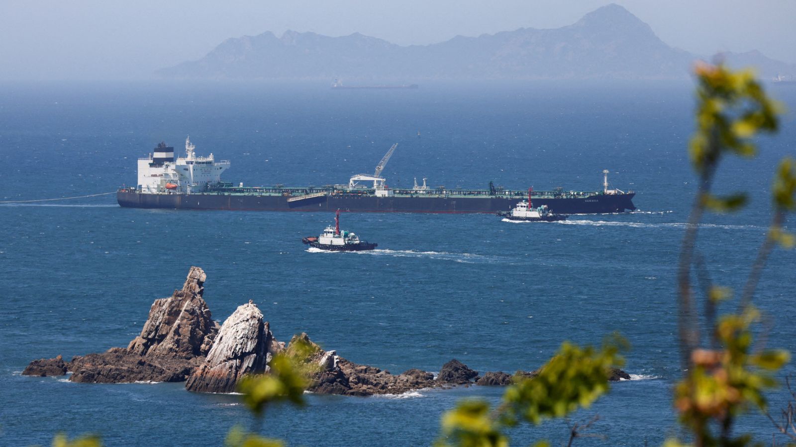 Tugboats guide the crude oil tanker Odessa, carrying UAE crude after passing through the Strait of Hormuz with its Automatic Identification System transponder turned off, navigates the waters at Daesan port, where it is expected to discharge crude oil, in Seosan, South Korea, May 8, 2026. (REUTERS)