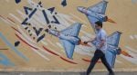 A man walks past an anti-Israel mural in downtown Tehran, Iran, Sunday, May 17, 2026. (AP Photo/Vahid Salemi)