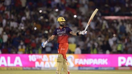 Virat Kohli of Royal Challengers Bengaluru raises his bat after scoring a fifty during Match 57. (Photo by Sumeet Parmar / CREIMAS for IPL)