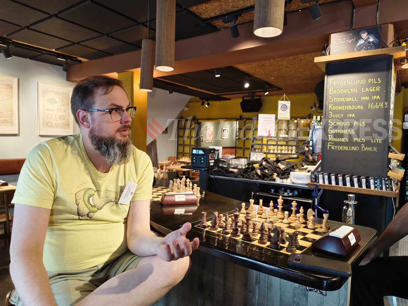 Kristoffer Gressli, one of the co-owners of The Good Knight, sits at the bar counter of the world's first chess-themed pub in Oslo. (Express Photo by Amit Kamath)