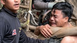 A rescued man is embraced, after seven Lao nationals who had entered a cave to prospect for gold were trapped for more than a week when rising water blocked their exit, in Xaisomboun province, Laos, May 30, 2026, in this screen grab. (REUTERS)