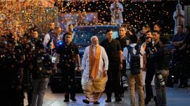 Confetti is sprayed as Indian Prime Minister Narendra Modi, center, arrives at the Bharatiya Janata Party (BJP) headquarters to celebrate victory in the recently held state assembly elections in New Delhi, India, Monday, May 4, 2026. (AP Photo/Manish Swarup)
