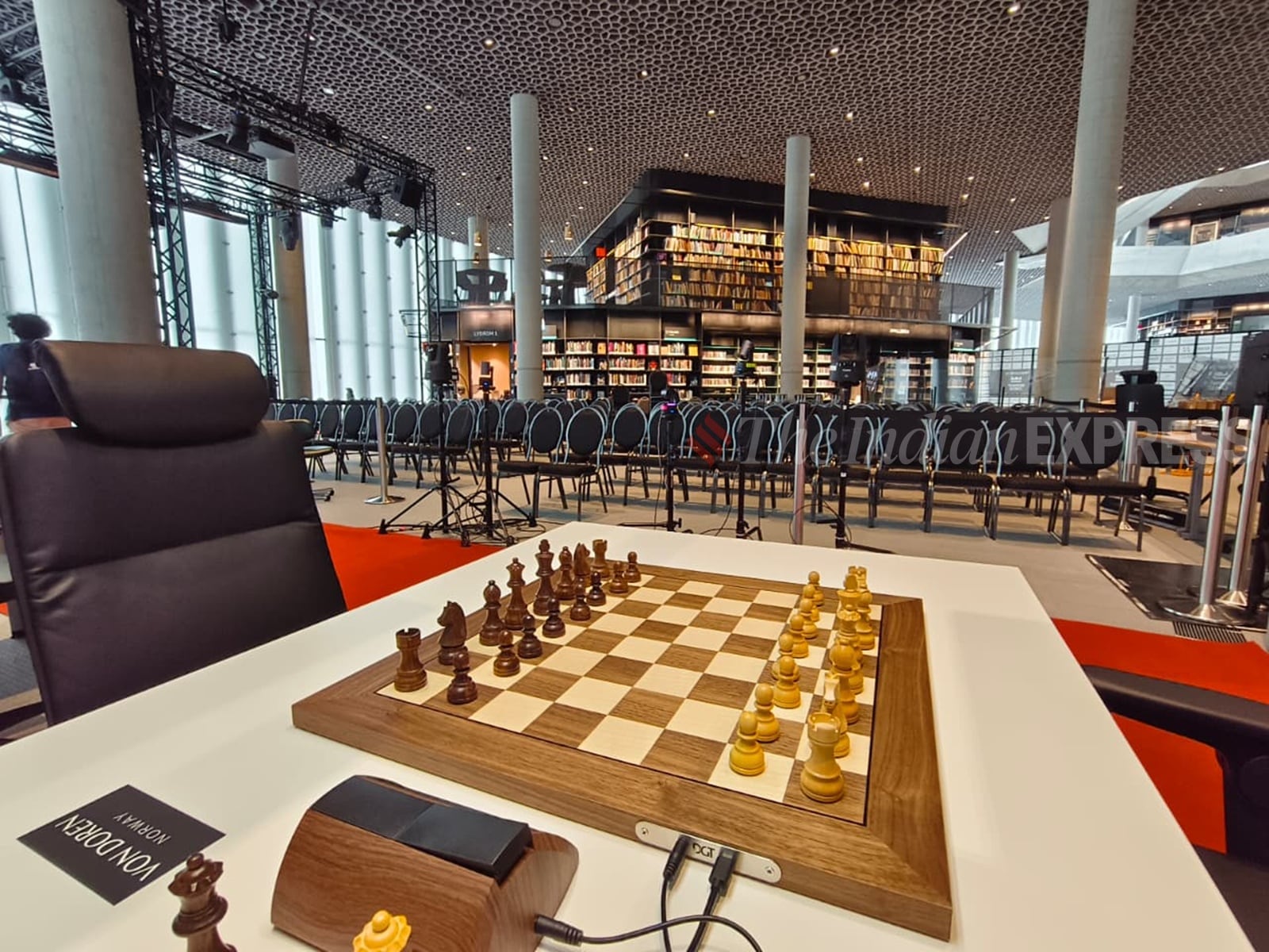 A playing board for this year's Norway Chess tournament with the library shelves in the background at the Deichman Bjørvika, a public library at Oslo. (Express photo by Amit Kamath)