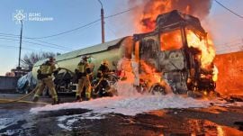 In this photo, provided by the Ukrainian Emergency Service, emergency services personnel work to extinguish a fire a vehicle following a Russian drone attack in Kyiv region, Ukraine, on May 5, (AP photo)