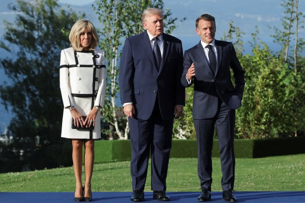 French President Emmanuel Macron and his wife, Brigitte Macron, prepare to pose for a picture with US President Donald Trump in Evian-les-Bains, June 15, 2026. (REUTERS)