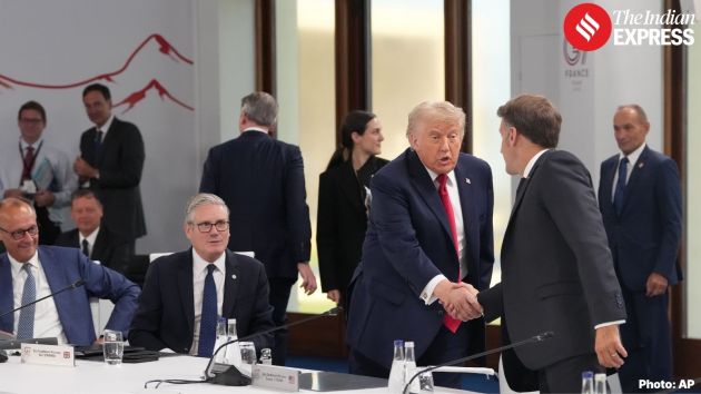 President Donald Trump, left, shakes hands with France's President Emmanuel Macron