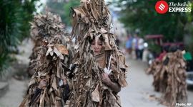 Catholic devotees covered in mud and dried banana leaves join the mud people festival on the feast day of Saint John the Baptist at Bibiclat