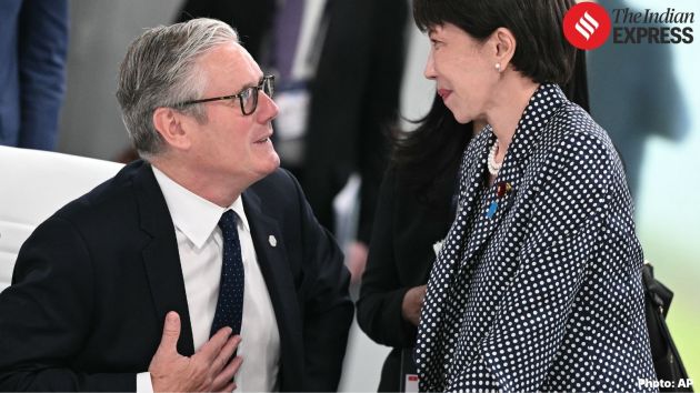Britain's Prime Minister Keir Starmer, left, speaks with Japan's Prime Minister Sanae Takaichi