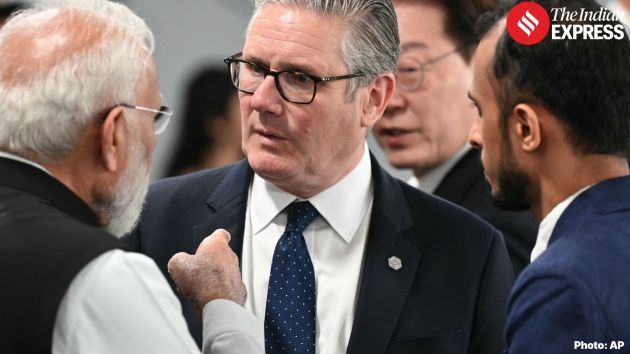 Britain's Prime Minister Keir Starmer, center, speaks with India's Prime Minister Narendra Modi