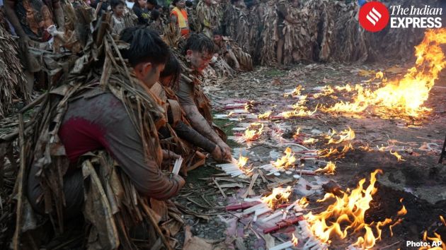 As they wait for Mass to begin, hymns are sung near a small fire