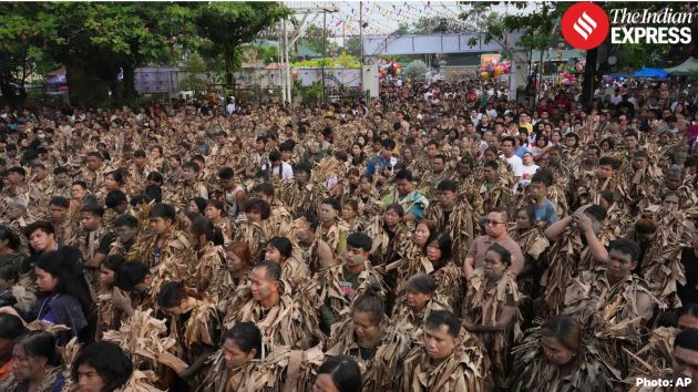Hundreds of Catholic devotees wrapped themselves in dried banana leaves and covered their bodies with mud on Wednesday