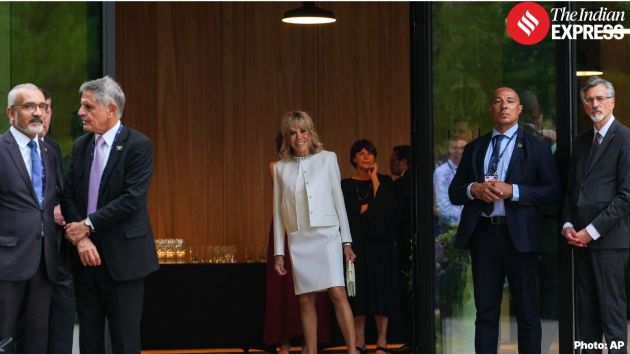 France's first lady Brigitte Macron watches as leaders gather for a group photo at the G7 summit