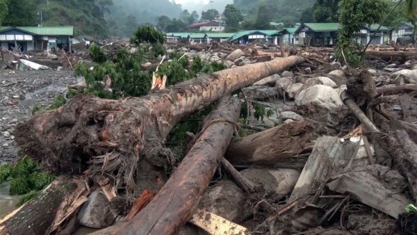  Uprooted trees and debris scattered across the area after a devastating flash flood at Possa village, in Keyi Panyor on Saturday. (ANI Video Grab)