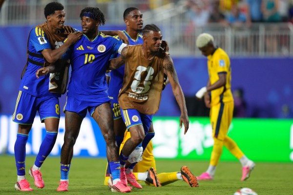 Curaçao's Leandro Bacuna and teammates celebrate after a draw against Ecuador. (AP Photo/Ed Zurga)