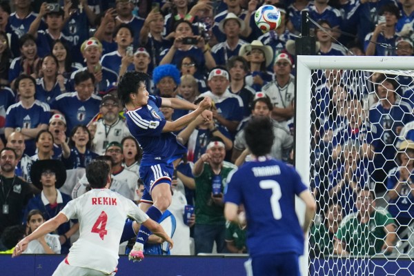 Japan's top-scorer in qualifying, Ueda doubled his count in the 86th when he leapt in the air to Kaishu Sano's flick and lobbed a header. (AP Photo)