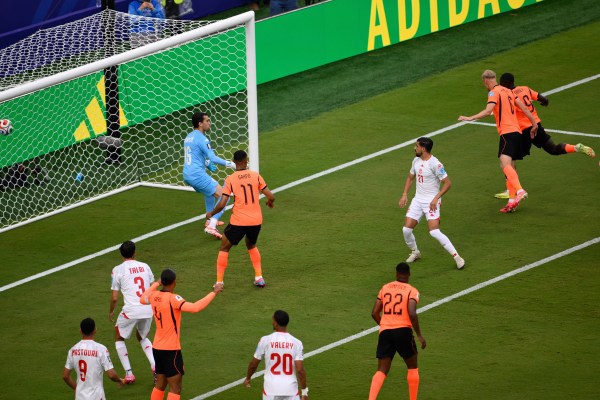 Netherlands' Brian Brobbey, far right, scores their second goal past Tunisia goalkeeper Aymen Dahmen. (AP Photo/Reed Hoffmann)