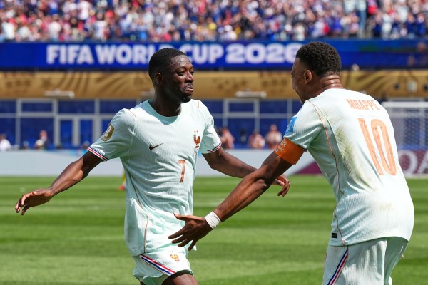 France's Ousmane Dembele celebrates with Kylian Mbappe, right, after scoring his side's third goal against Norway. (AP Photo/Martin Meissner)