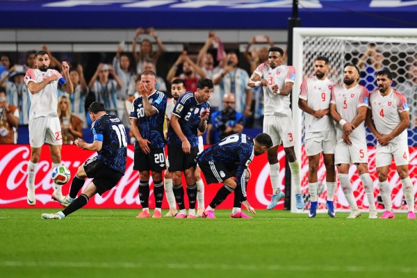 Messi curls the free-kick around the Jordan wall for his 19th World Cup goal. (AP Photo/Julio Cortez)