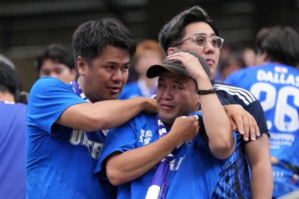 Japanese fan cries after the World Cup round of 32 match between Brazil and Japan in Houston. (AP Photo/Karen Warren)