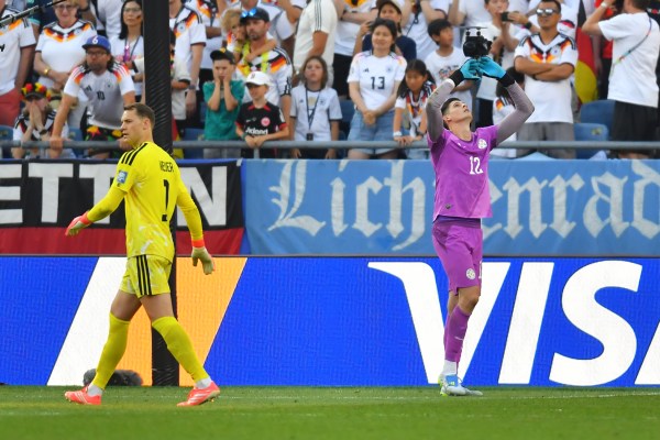 Paraguay goalkeeper Orlando Gill (12) celebrates after blocking a shot by Germany's Nick Woltemade in a shootout, as Manuel Neuer (1) walks into position. (AP Photo/Steven Senne)