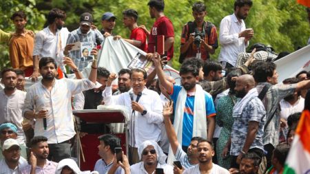 Cockroach Janta Party's (CJP) founder Abhijeet Dipke (in white) and others raise slogans during a protest demanding the resignation of Union Education Minister Dharmendra Pradhan over alleged examination-related lapses, at the Jantar Mantar, in New Delhi, Saturday. (PTI Photo)