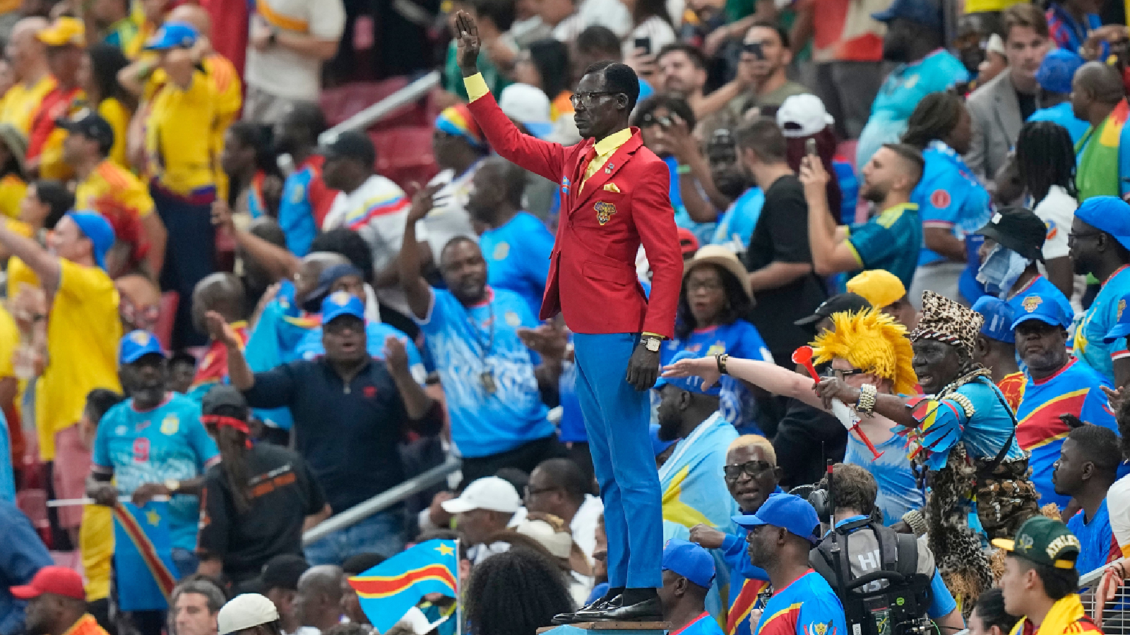 Congo supporter Michel Nkuka Mboladinga poses as a statue of the country's assassinated independence hero Patrice Lumumba ahead of the World Cup Group K soccer match between Colombia and Congo in Zapopan, near Guadalajara, Mexico, Tuesday, June 23, 2026. (AP Photo/Fernando Llano)