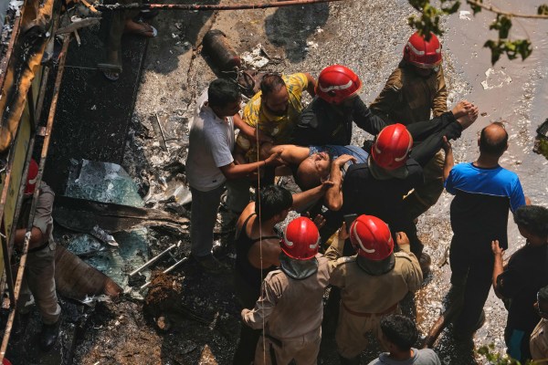 Firefighters rescue a foreign national from a hotel fire in New Delhi, India, Wednesday, June 3, 2026. (AP Photo/Manish Swarup)