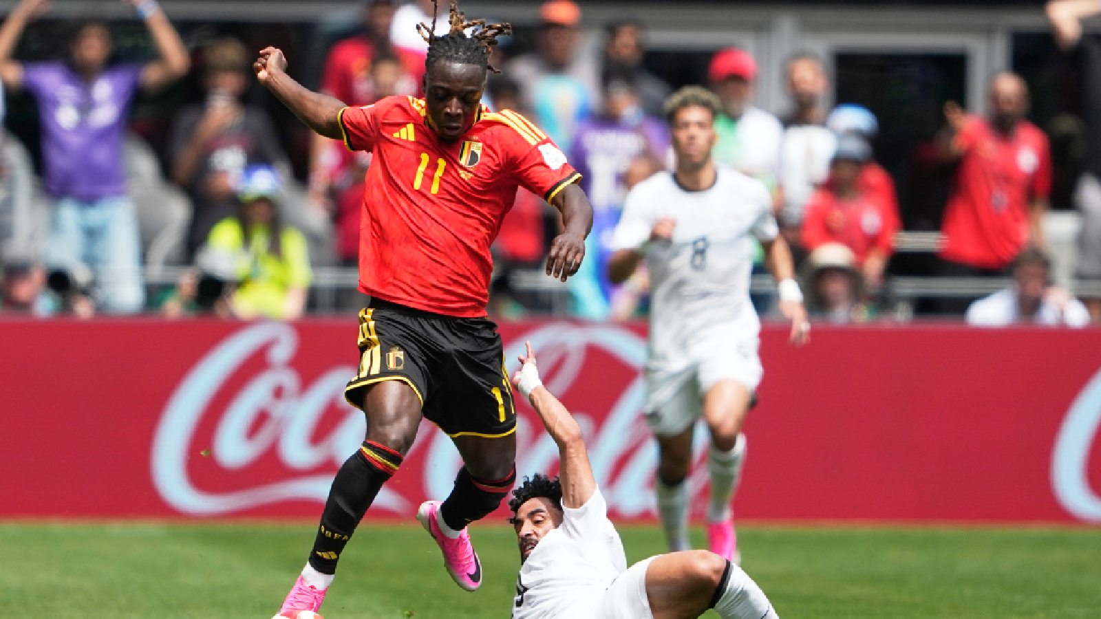 Belgium's Jeremy Doku, top, and Egypt's Marawan Attia battle for the ball during the World Cup Group G soccer match in Seattle, Monday, June 15, 2026. (AP Photo/Lindsey Wasson)