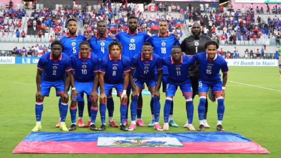 Haiti national soccer team players pose for a team photo at the start of an international friendly soccer match against Peru, Friday, June 5, 2026, in Miami. (AP Photo/Rebecca Blackwell)